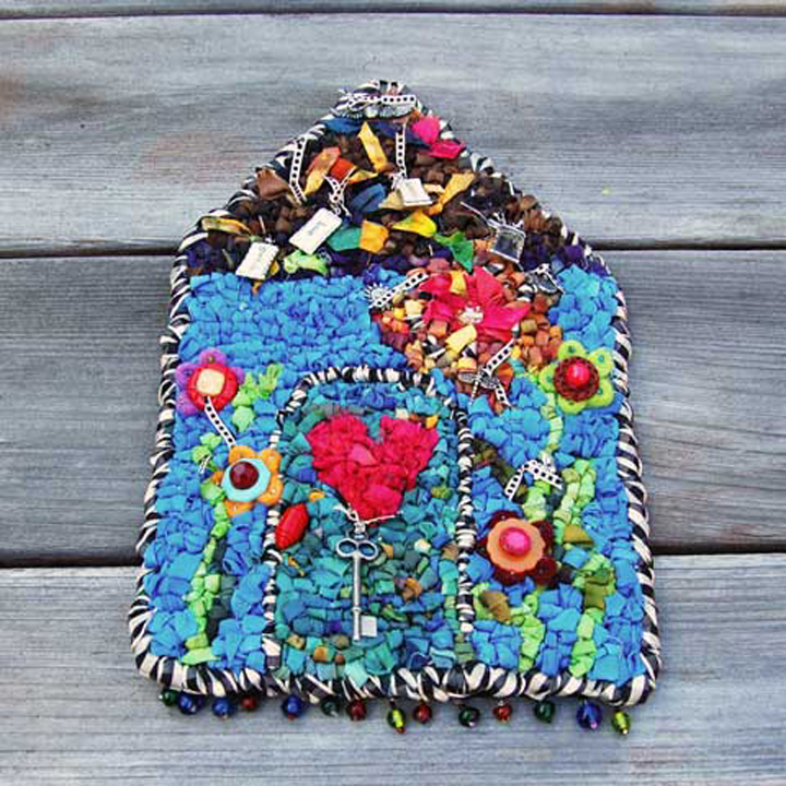 Design by Cathren BrittFeatured in the “Hook, Loop, & Lock” book. Mixed media with fabric strips, ribbon, charms, buttons, felt pieces, beaded fringe. Make with either 5-mesh or 3.75 mesh canvas.